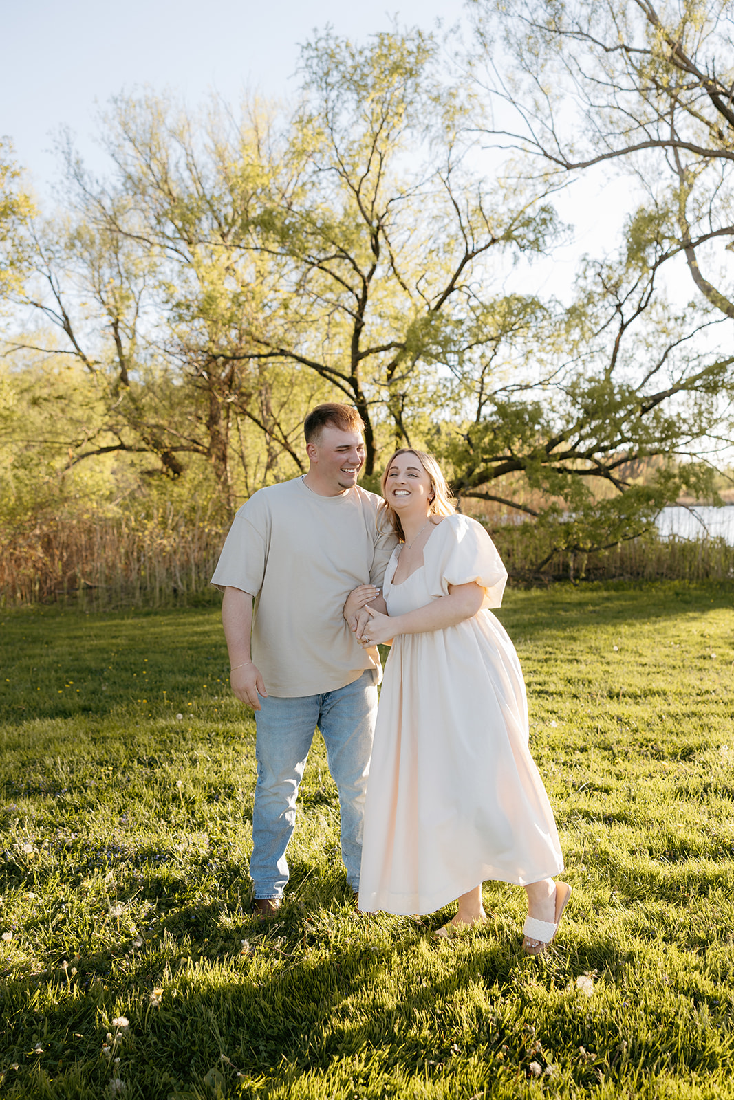 Engagement Session Couples Photo at Hamlin Beach State Park laughing together documented by TPI Photography a Rochester NY Wedding Photographer