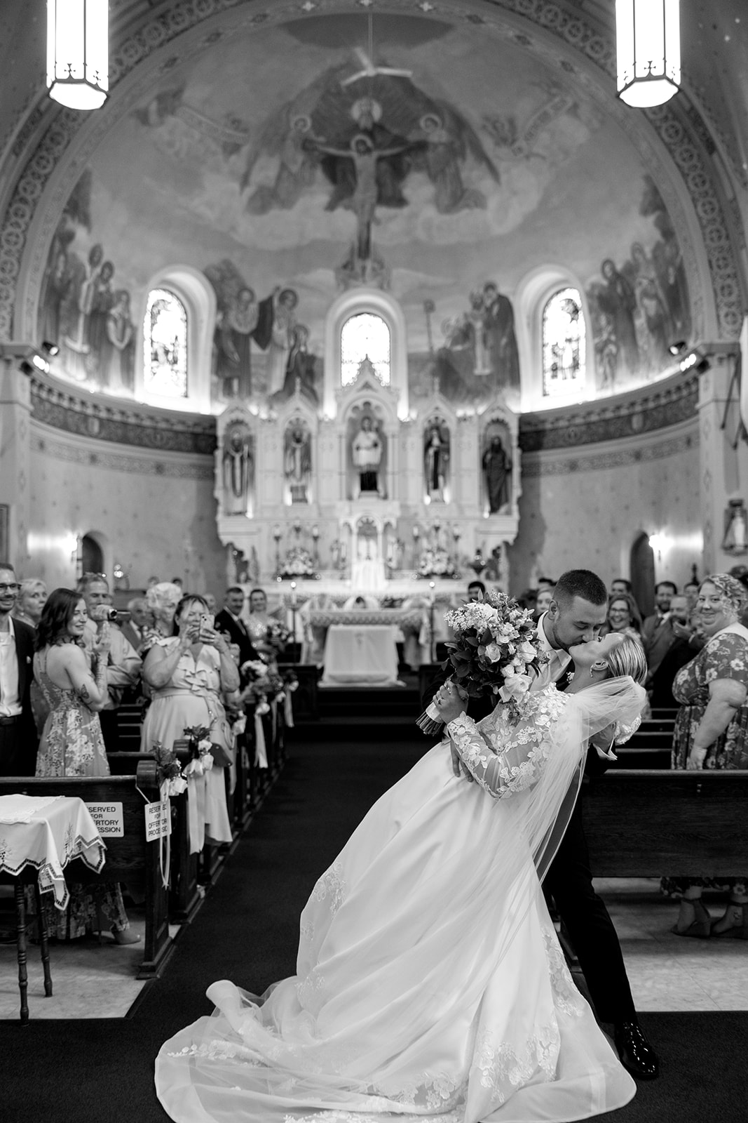 bride and groom kissing during the recessional