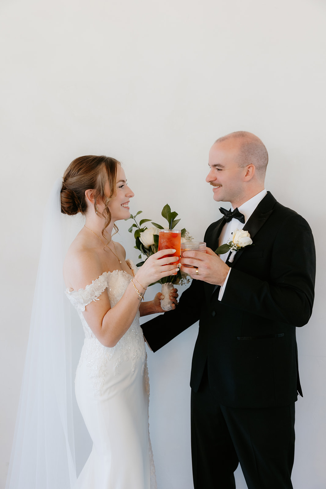 bride and groom celebrating with their signature cocktails at their wedding at arbor loft