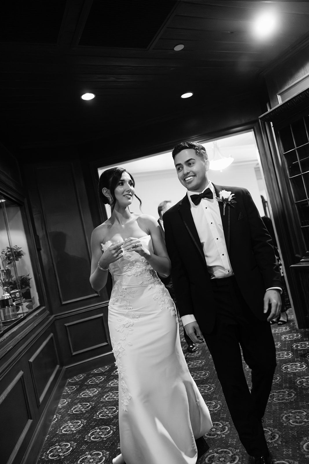bride and groom walking into cocktail hour